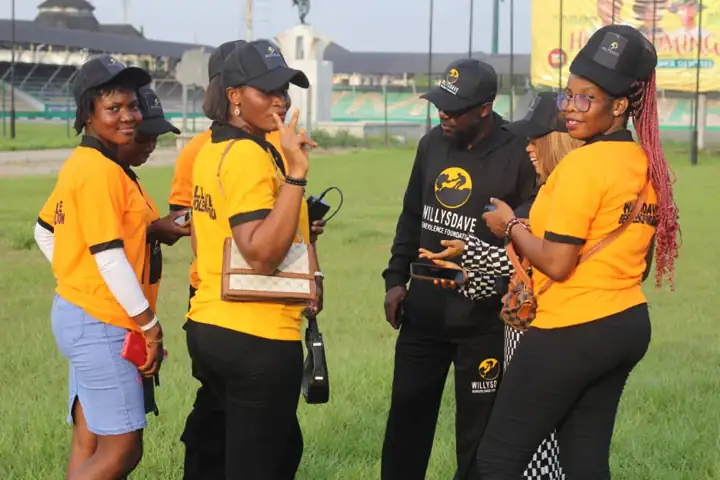 WillysDave volunteers in orange tees at the outreach ground