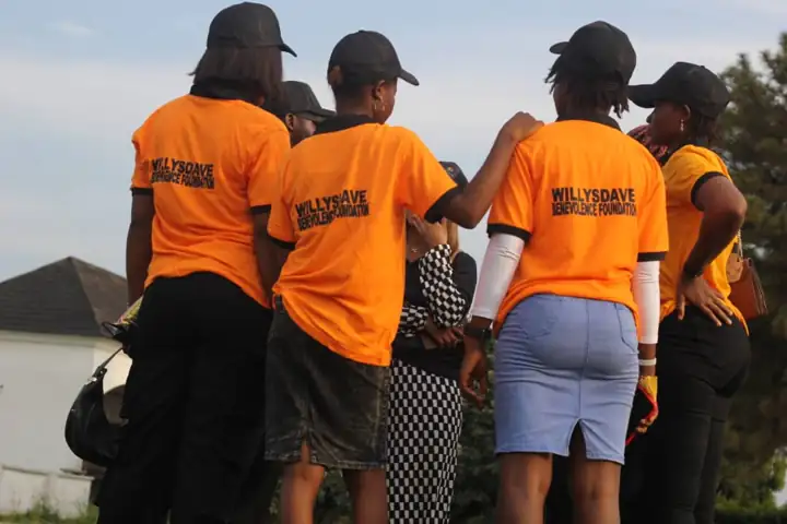 WillysDave volunteers in orange tees at the outreach ground